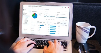 Person using Google Analytics on MacBook Air
